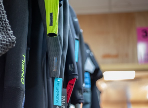 wetsuits-hanging-up